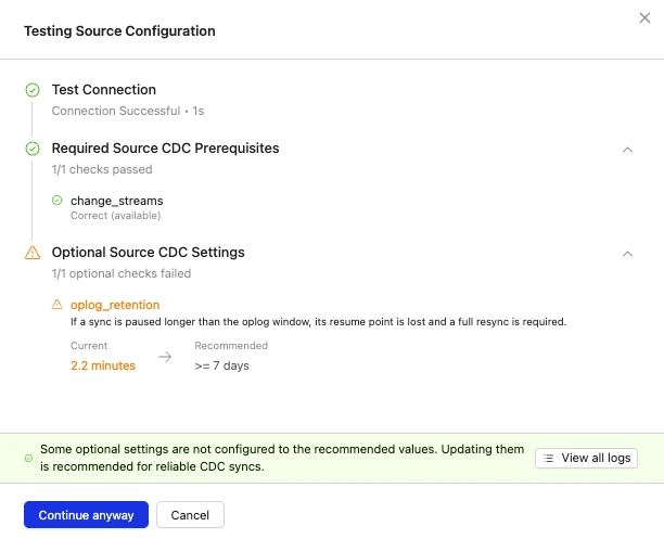 Testing Source Configuration modal showing connection success, required change_streams check, and optional oplog_retention warning with Continue anyway